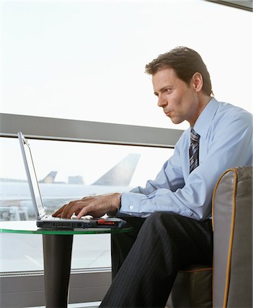 simsearch:700-02797980,k - Businessman using Laptop at Airport Stock Photo - Rights-Managed, Code: 700-02887140