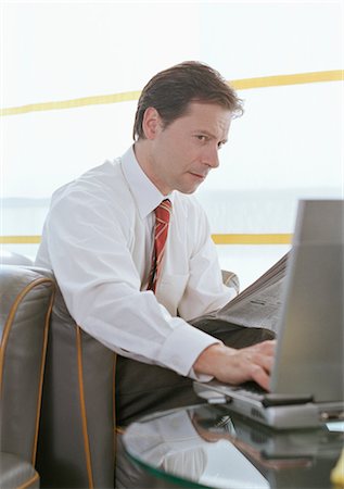 simsearch:700-02797980,k - Businessman using Laptop at Airport Stock Photo - Rights-Managed, Code: 700-02887141