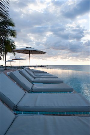 seating at the pool - Lounge Chairs by Infinity Pool, Grand Bahama Island, Bahamas Stock Photo - Rights-Managed, Code: 700-02887315