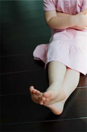 stubborn - Petite fille assise sur le plancher de bois franc Photographie de stock - Rights-Managed, Code: 700-02922738