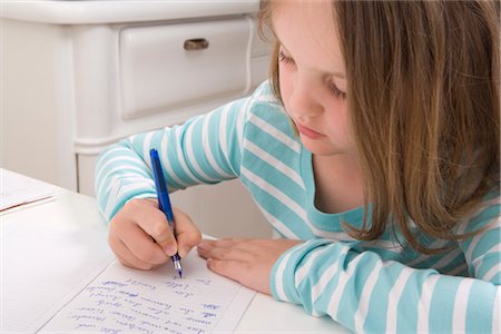 student young writing - Girl Doing Homework Stock Photo - Rights-Managed, Code: 700-02935702