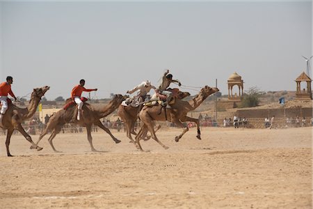 riding on a camel in the desert - Camel Festival, Jaisalmer, Rajasthan, India Stock Photo - Rights-Managed, Code: 700-02957994