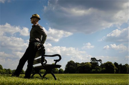 Man Leaning on Park Bench Looking into the Distance Stock Photo - Rights-Managed, Code: 700-02989987