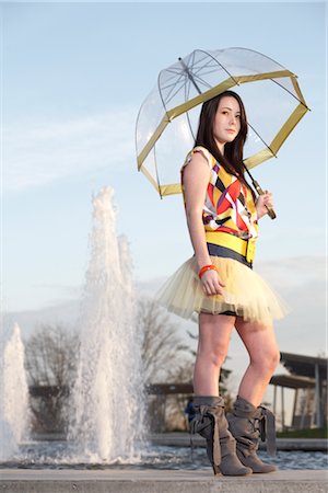 Young Woman Holding Umbrella by Water Fountain Stock Photo - Rights-Managed, Code: 700-03004261