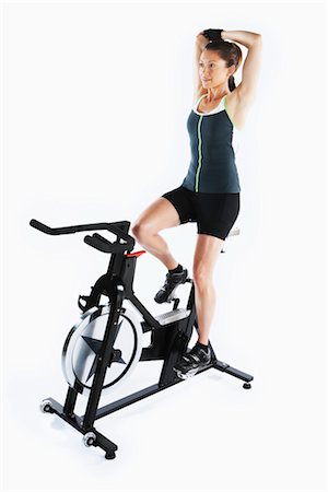 Woman Riding Stationary Bicycle Stock Photo - Rights-Managed, Code: 700-03004410