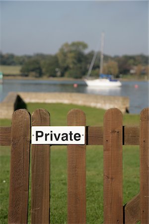 post (structural support) - Private Sign on Fence, Yacht on River in the Background Stock Photo - Rights-Managed, Code: 700-03017091