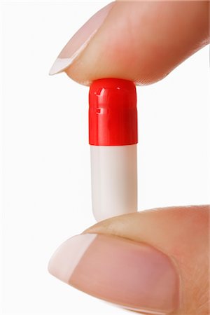 Woman Holding Pill Stock Photo - Rights-Managed, Code: 700-03017675