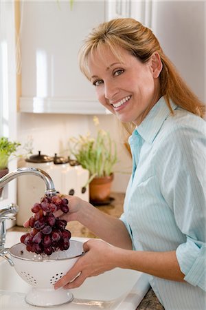 Woman Rinsing Grapes Stock Photo - Rights-Managed, Code: 700-03017711