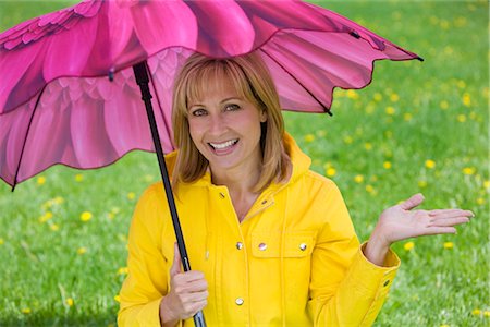 simsearch:700-00015310,k - Woman Wearing Raincoat and Holding Umbrella Foto de stock - Con derechos protegidos, Código: 700-03017736
