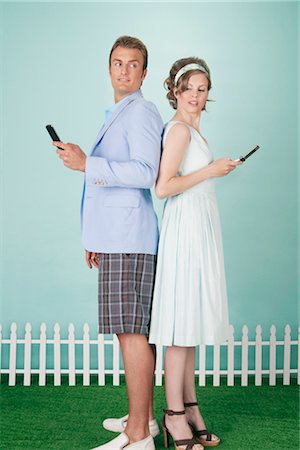 people opposite sides - Couple Standing Back to Back Sending Text Messages Stock Photo - Rights-Managed, Code: 700-03059124