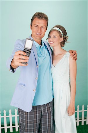 smile couple taking picture phone - Couple Taking a Picture of Themselves With a Camera Phone Stock Photo - Rights-Managed, Code: 700-03059125