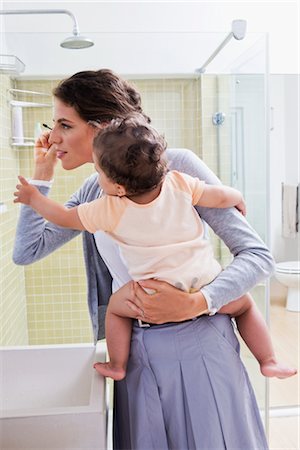 Mother Holding Baby and Applying Make-up Stock Photo - Rights-Managed, Code: 700-03068735