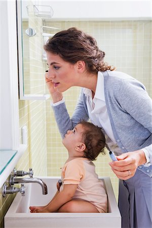 Mother with Baby Applying Make-up Stock Photo - Rights-Managed, Code: 700-03068739