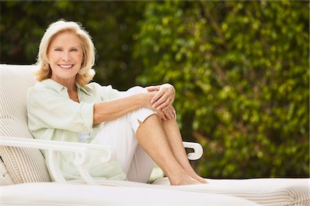 Portrait of Woman Sitting on Lounge Chair Stock Photo - Rights-Managed, Code: 700-03075333