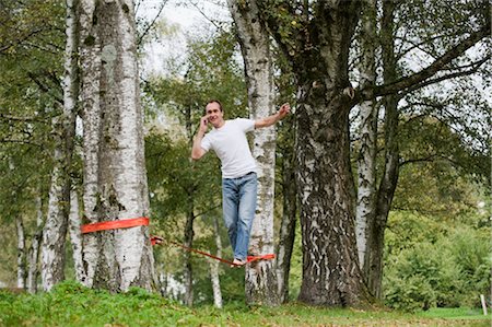 simsearch:700-03179177,k - Man Slacklining and Talking on the Phone Stock Photo - Rights-Managed, Code: 700-03161673