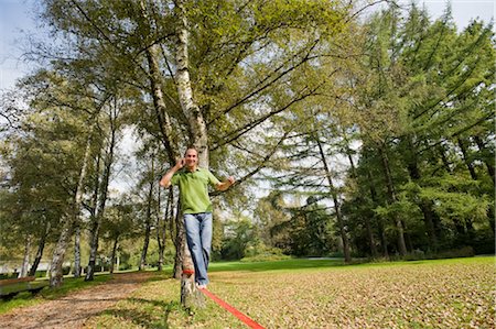 simsearch:700-03179164,k - Man Slacklining and Talking on the Phone Stock Photo - Rights-Managed, Code: 700-03161684