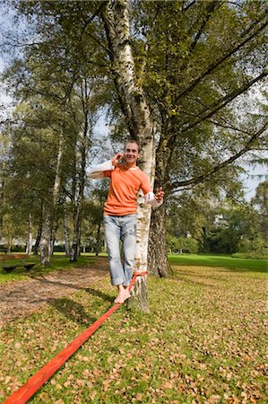 simsearch:700-03179164,k - Man Slacklining and Talking on the Phone Stock Photo - Rights-Managed, Code: 700-03161687