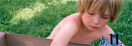 Little Boy Playing in Garden, Argentan, Orne, Normandy, France Stock Photo - Rights-Managed, Code: 700-03178401