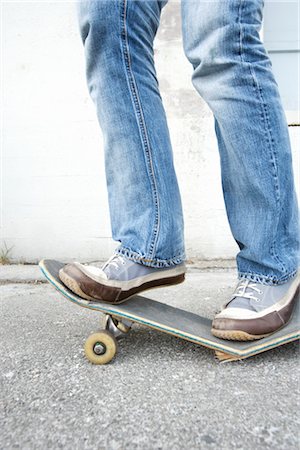 pictures of shoes for 15 year old girls - Teenager Standing on Broken Skateboard Stock Photo - Rights-Managed, Code: 700-03178528