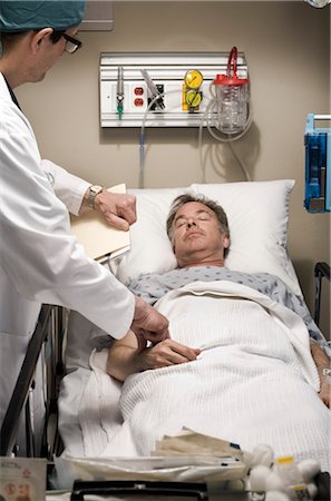 patient with monitors in hospital - Doctor Taking Pulse of Patient Stock Photo - Rights-Managed, Code: 700-03210509