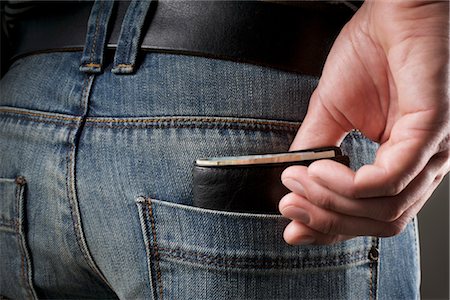 Man taking Wallet out of Pocket Stock Photo - Rights-Managed, Code: 700-03229753