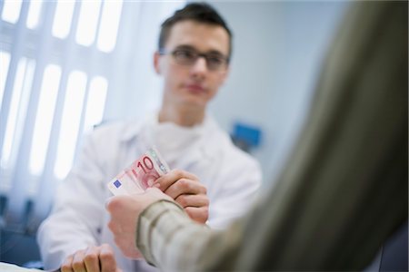 paying with cash - Portrait of Doctor Stock Photo - Rights-Managed, Code: 700-03284306