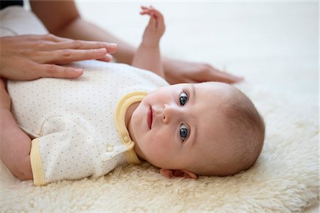 family lying on carpet - Portrait of Baby having Tummy Rubbed Stock Photo - Rights-Managed, Code: 700-03294889