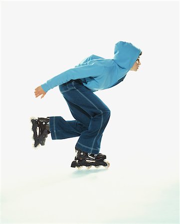 side profile of woman in hoodie - Woman Rollerblading Stock Photo - Rights-Managed, Code: 700-03299202