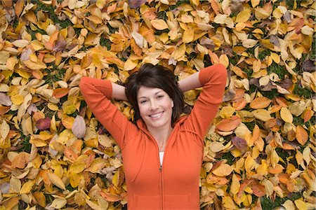 person lying on back hands behind head - Woman Lying Down on Autumn Leaves Stock Photo - Rights-Managed, Code: 700-03290239