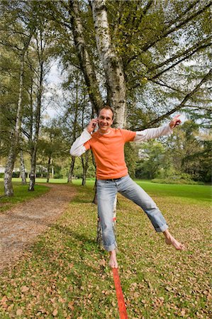 simsearch:700-03179177,k - Man Balancing on slackline and Talking on Cell Phone Stock Photo - Rights-Managed, Code: 700-03333135