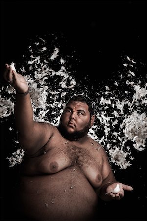 fat person arms up - Man Covered in Feathers, Holding Birds in His Hands Stock Photo - Rights-Managed, Code: 700-03361647