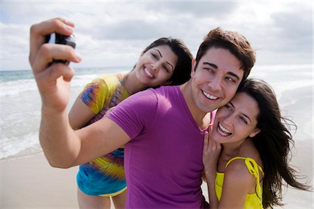 Friends Taking a Picture of Themselves on the Beach Fotografie stock - Rights-Managed, Codice: 700-03392500