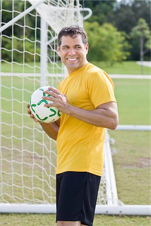 Man Holding Soccer Ball, Playing Soccer Stock Photo - Rights-Managed, Code: 700-03406468