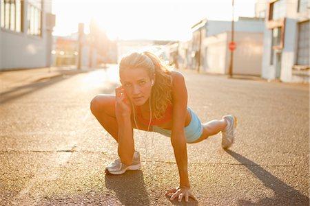 exercise wear for women - Woman Stretching and Listening to MP3 Player Stock Photo - Rights-Managed, Code: 700-03407838