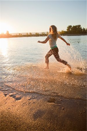 Woman Running through Water in River, Oregon, USA Stock Photo - Rights-Managed, Code: 700-03407886