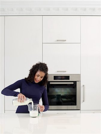 pitcher of milk - Woman Measuring Milk Stock Photo - Rights-Managed, Code: 700-03407950