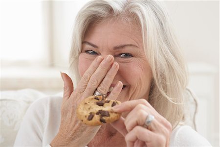 person holding cookie - Woman Eating a Cookie Stock Photo - Rights-Managed, Code: 700-03439018