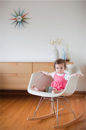 Baby Girl Sitting in a Rocking Chair Stock Photo - Rights-Managed, Code: 700-03439472