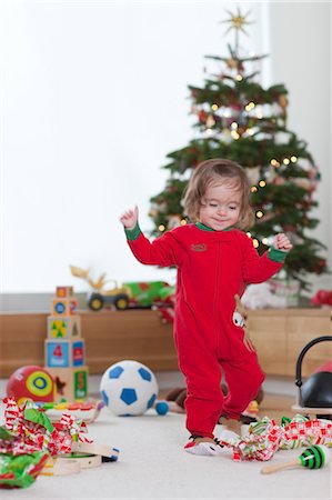 single christmas ball ornament - Little Girl Unwrapping Toys next to Christmas Tree Stock Photo - Rights-Managed, Code: 700-03439535