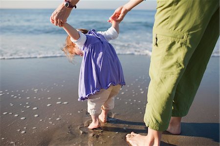 rear view of two children holding hands - Back View of Mother holding Young Daughter's Hands, Standing on Beach, Long Beach, California, USA Stock Photo - Rights-Managed, Code: 700-03439545