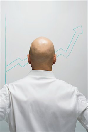 statistics - Businessman Looking at Graph Foto de stock - Con derechos protegidos, Código: 700-03439582