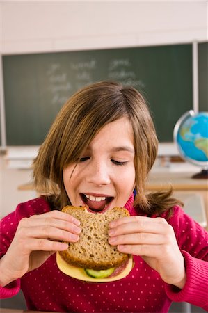 school child desk - Girl Eating Lunch in School Stock Photo - Rights-Managed, Code: 700-03445050