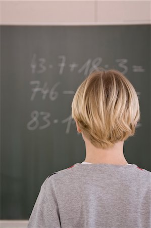 fourniture scolaire - Student Trying to Solve Math Equation Foto de stock - Con derechos protegidos, Código: 700-03445070