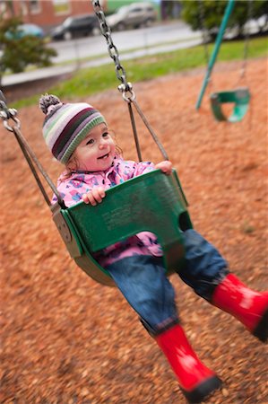 rubber boots young girl - Girl in Swing, Portland, Oregon, USA Stock Photo - Rights-Managed, Code: 700-03455585