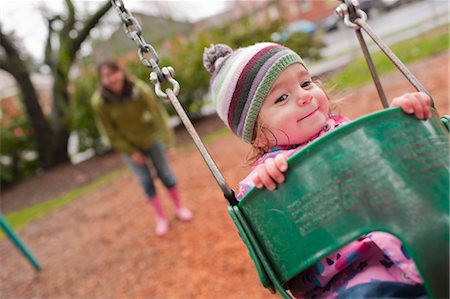 parent and child on playground - Girl in Swing, Portland, Oregon, USA Stock Photo - Rights-Managed, Code: 700-03455587