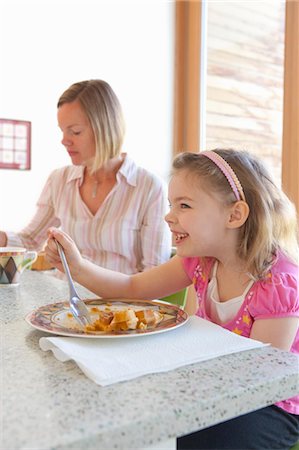 people kitchen island - Mère et fille manger dans la cuisine Photographie de stock - Rights-Managed, Code: 700-03455671