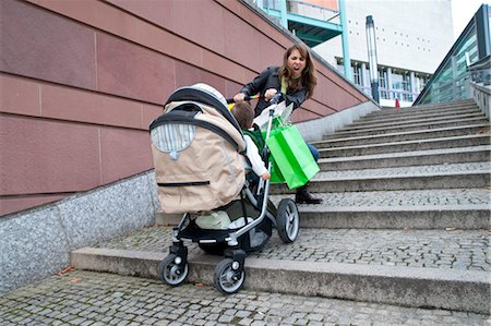 Femme aux prises avec la poussette dans les escaliers Photographie de stock - Rights-Managed, Code: 700-03456186