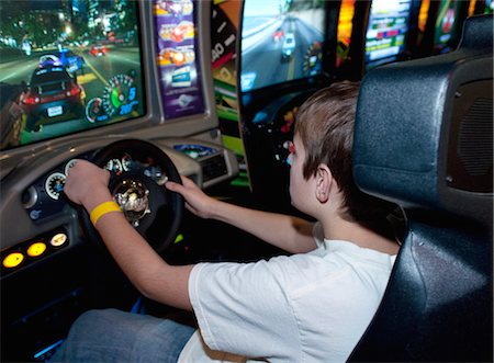 Boy Playing Arcade Game Stock Photo - Rights-Managed, Code: 700-03456791