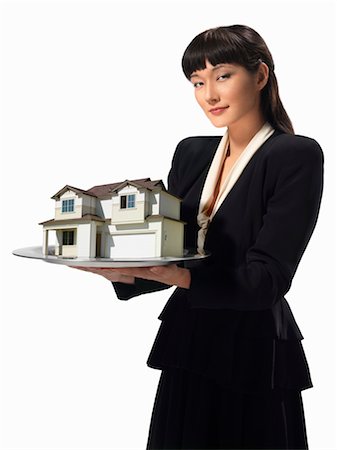 Businesswoman holding Model of House on Silver Tray Fotografie stock - Rights-Managed, Codice: 700-03466511