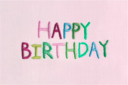 Happy Birthday Embroidered on Pink Fabric Foto de stock - Con derechos protegidos, Código: 700-03478616